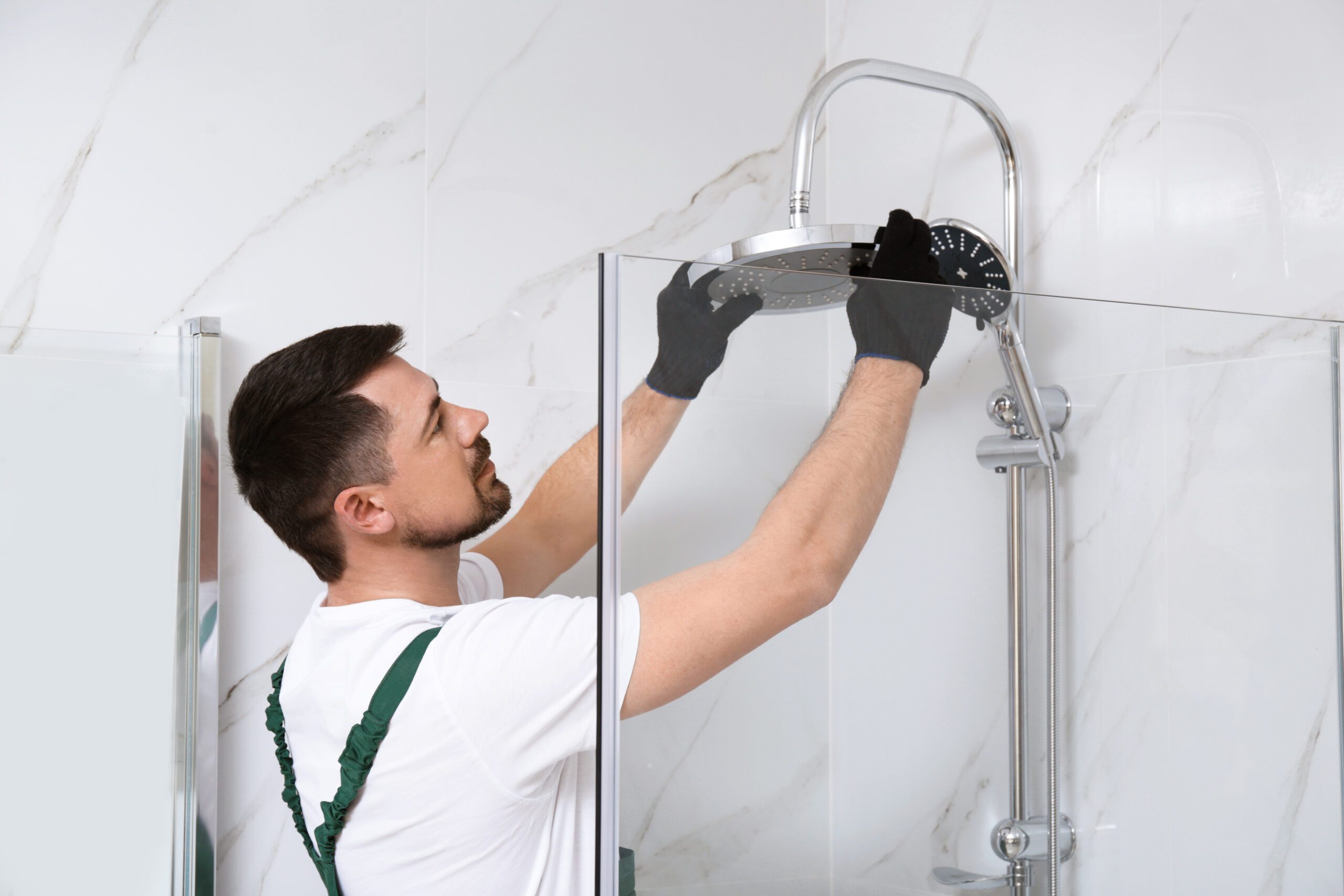 A Professional Plumber Installs A Shower