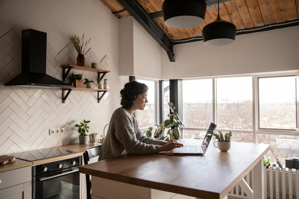 A woman using a laptop at the dining table